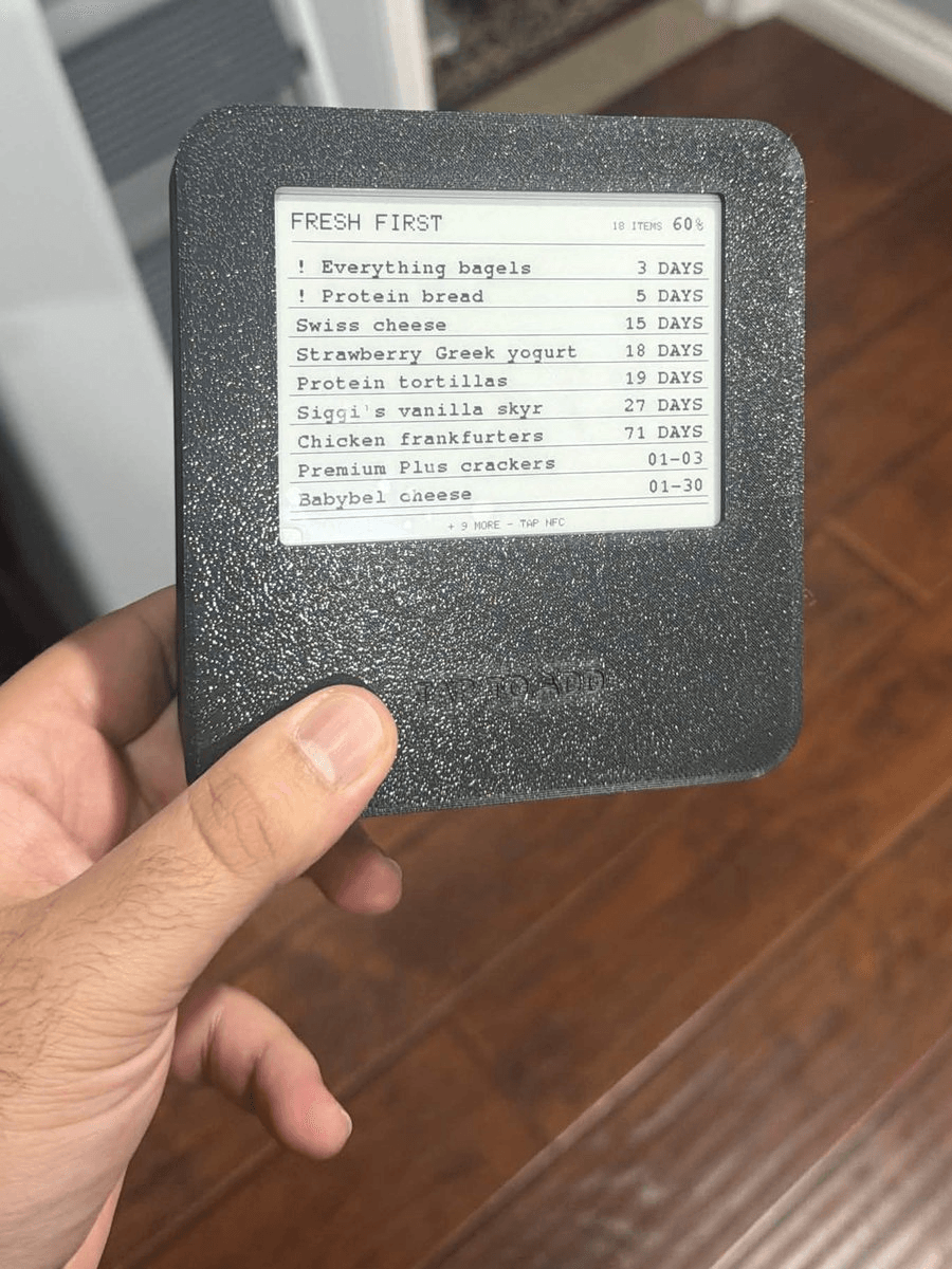 The finished Fresh First prototype in its enclosure, showing an expiry-sorted grocery list and battery level on the e-paper display.