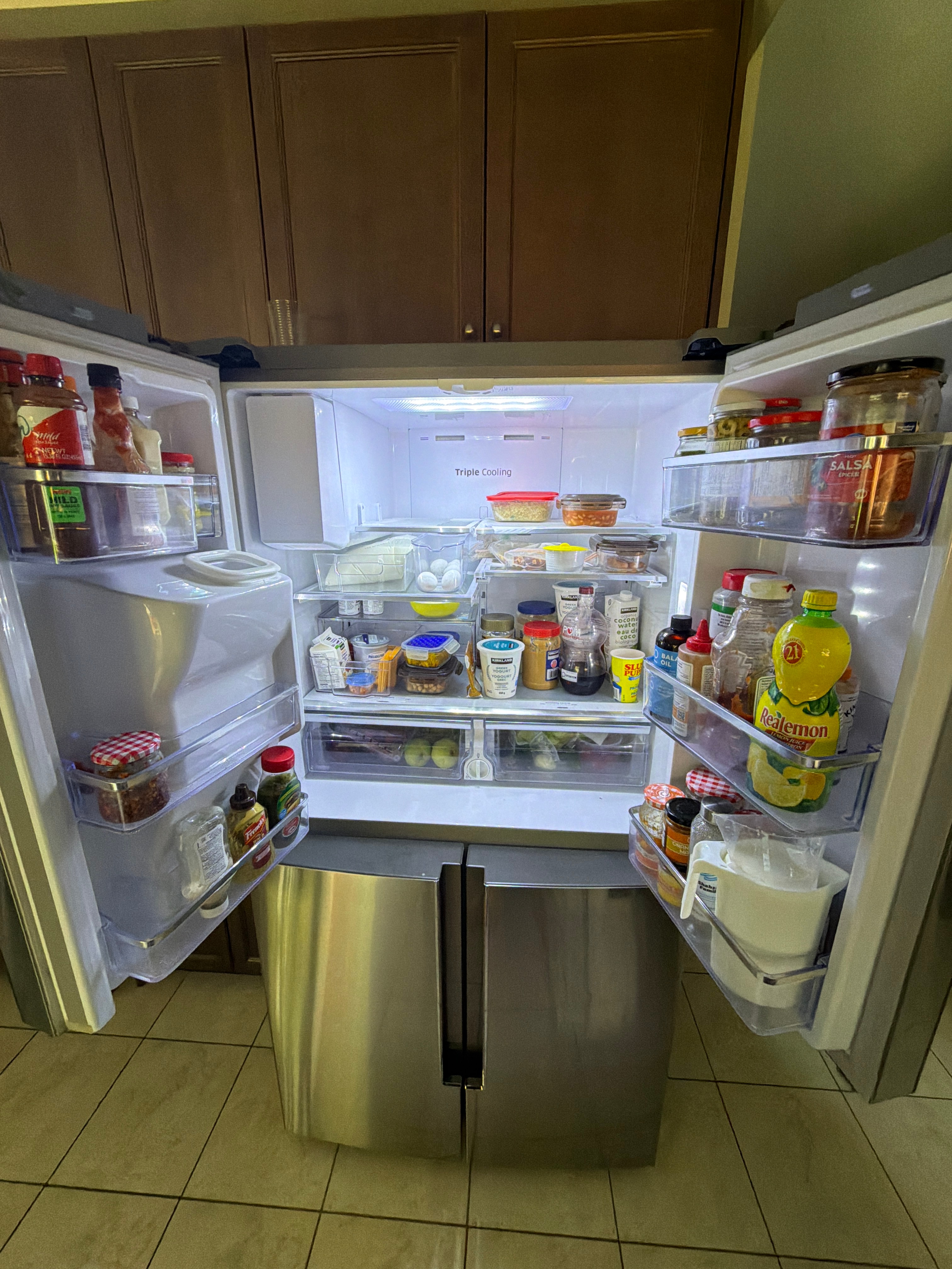 Shaaf's open fridge, filled with groceries across its shelves and door compartments.