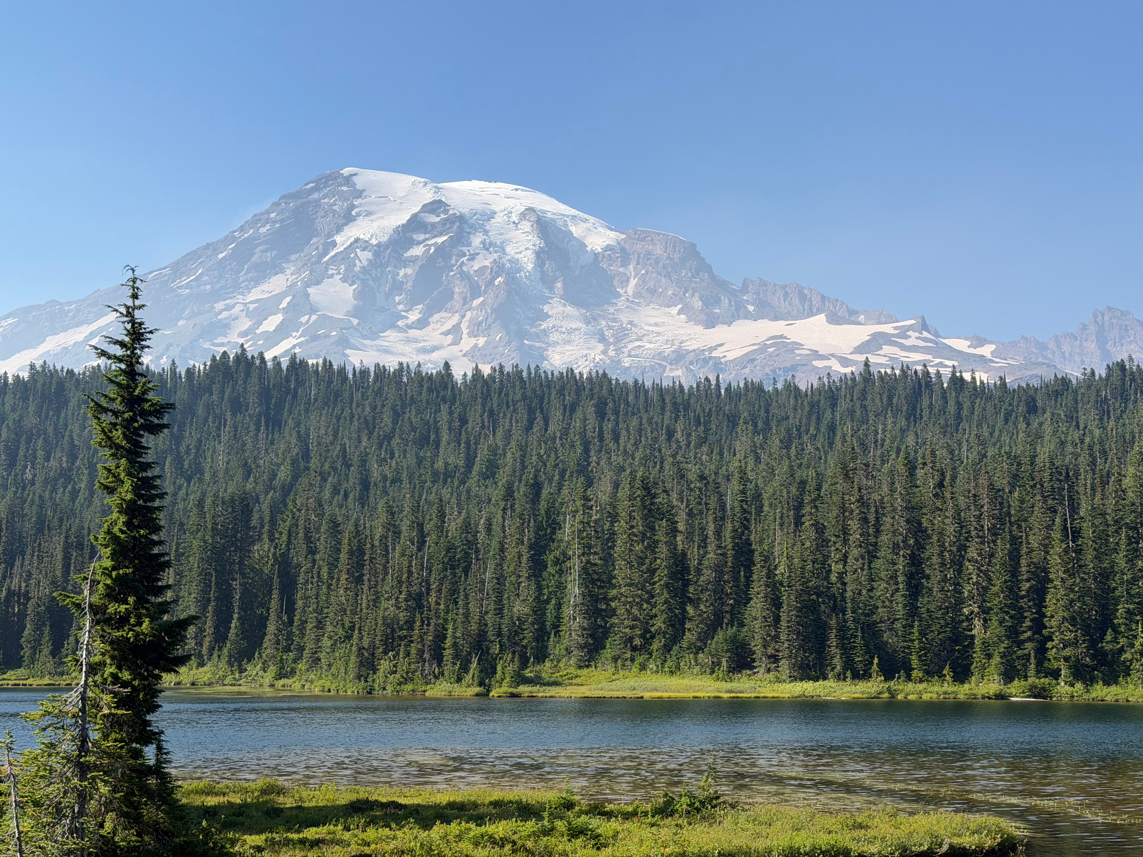 Mount Rainier rising above a forest and lake on Shaaf's recent trip.