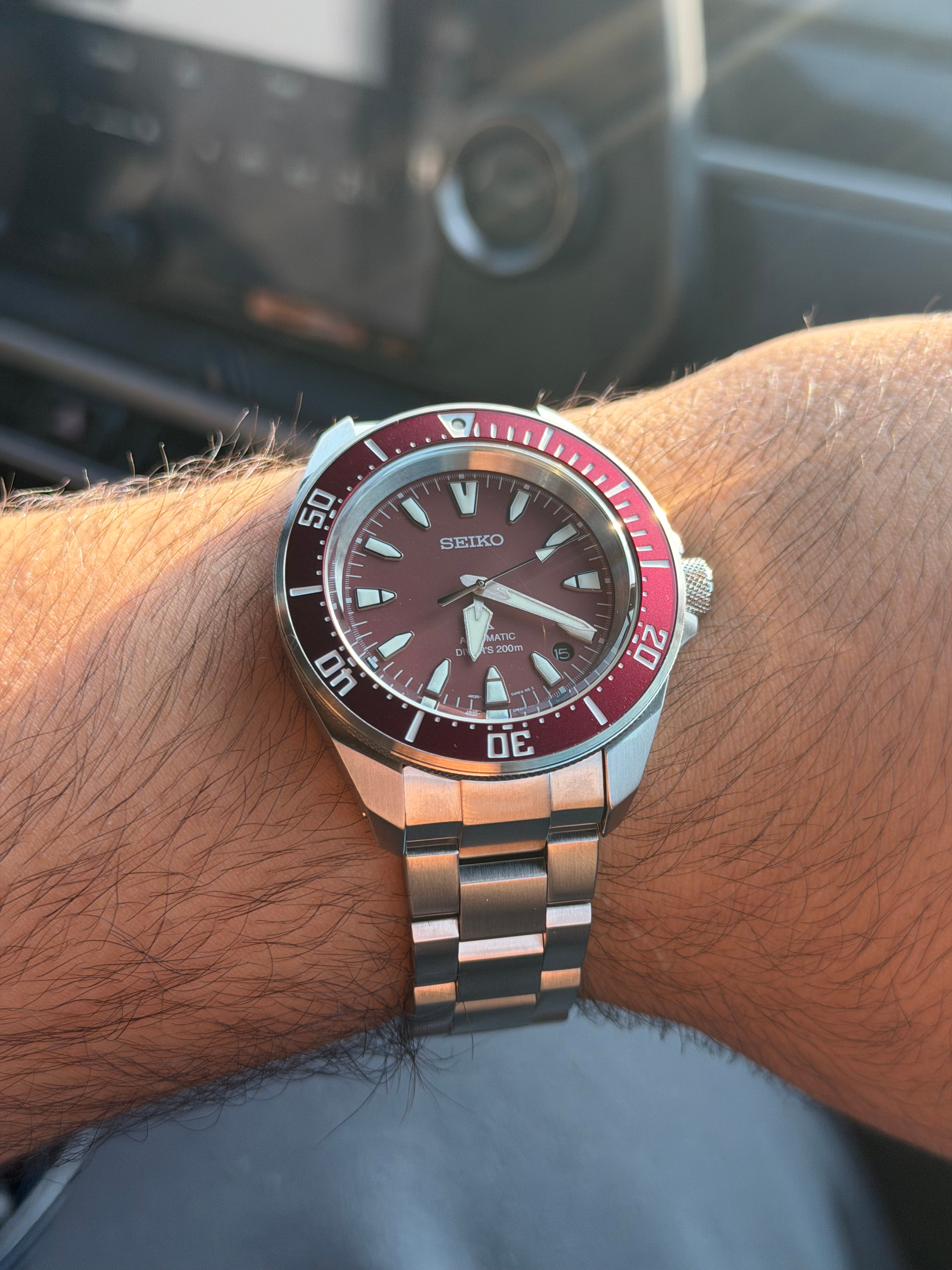 A red Seiko Prospex automatic dive watch on Shaaf's wrist.