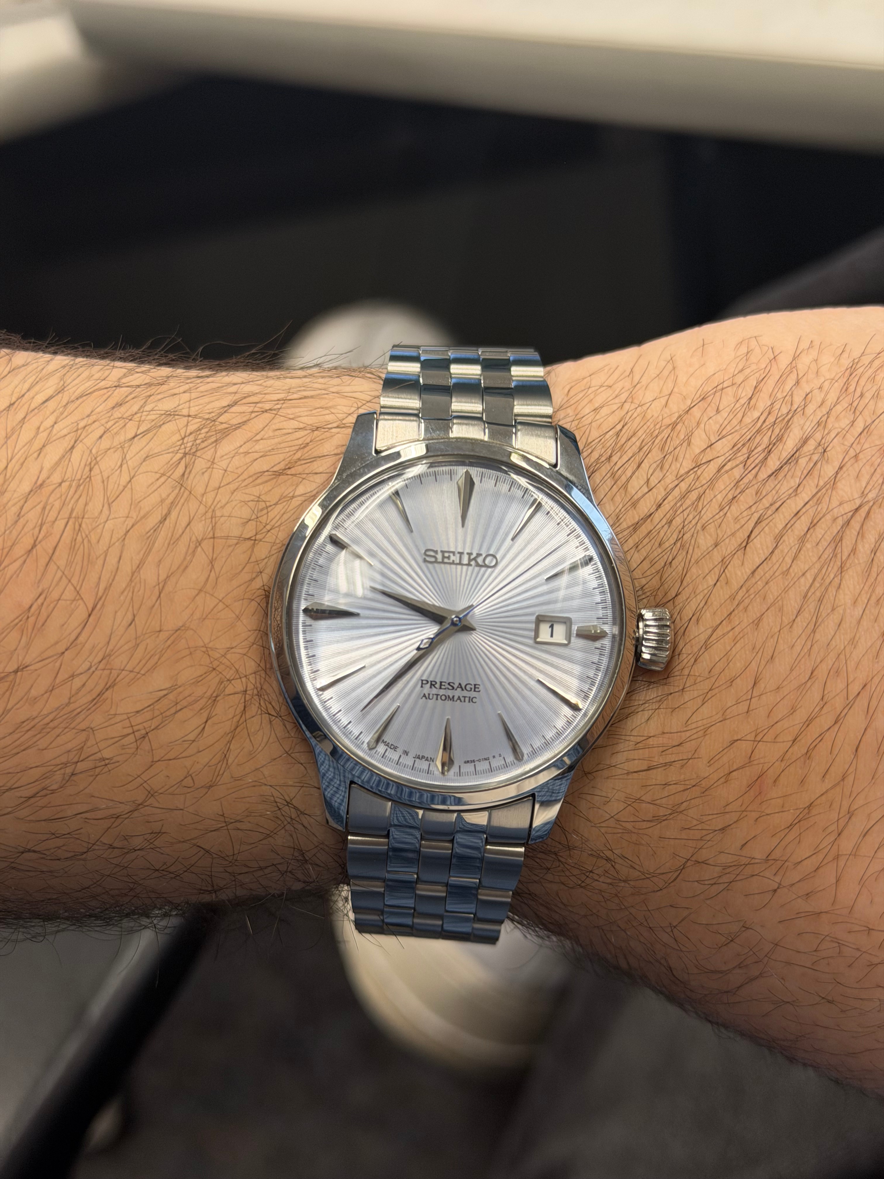 A silver-dial Seiko Presage automatic watch on Shaaf's wrist.