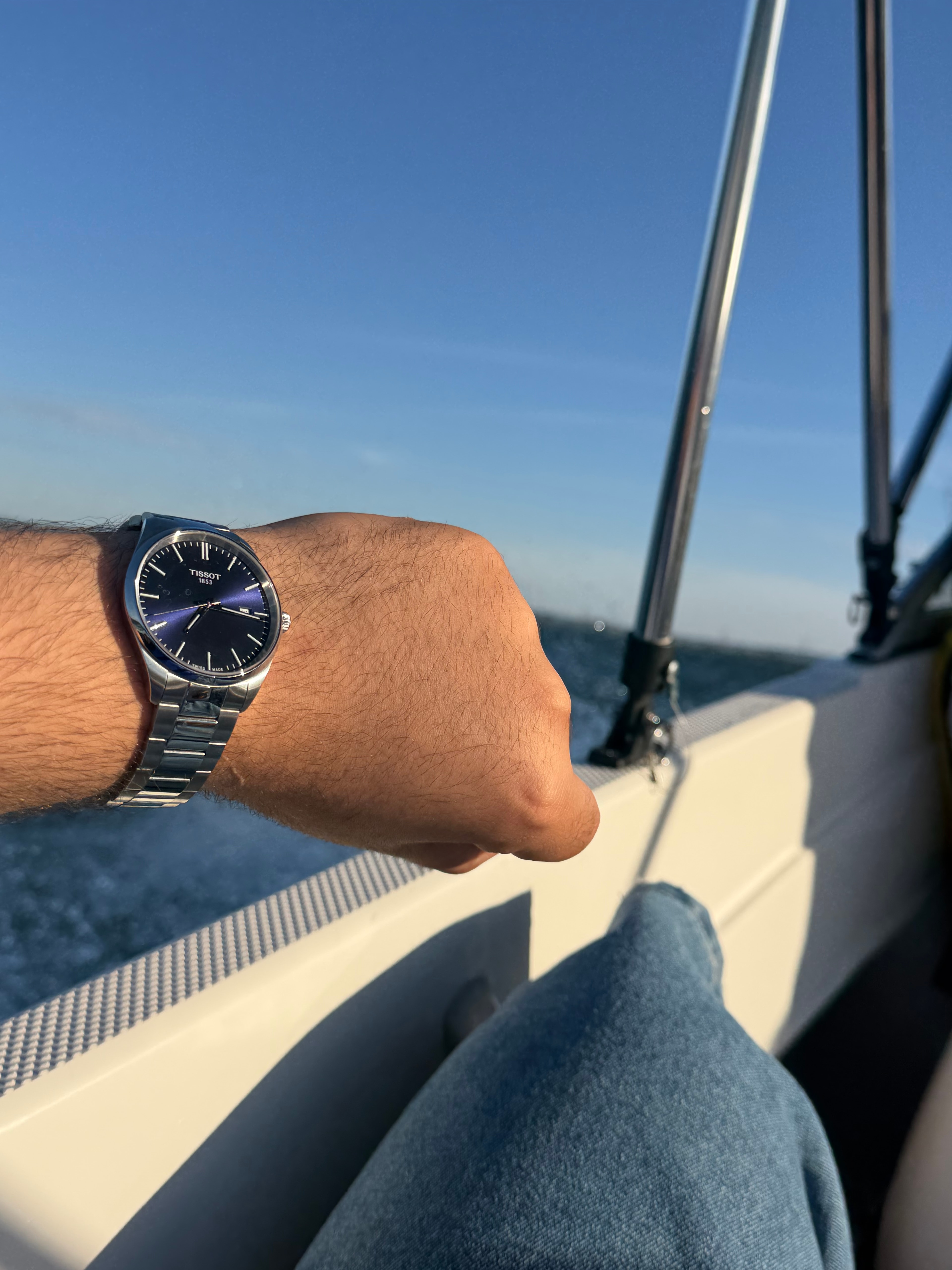 A blue-dial Tissot watch on Shaaf's wrist during a boat ride.